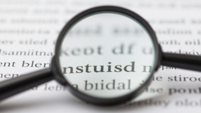 magnifying glass enlarging text on paper